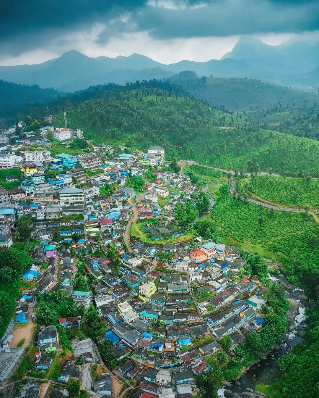 Aerial view of a hill town among tea estates